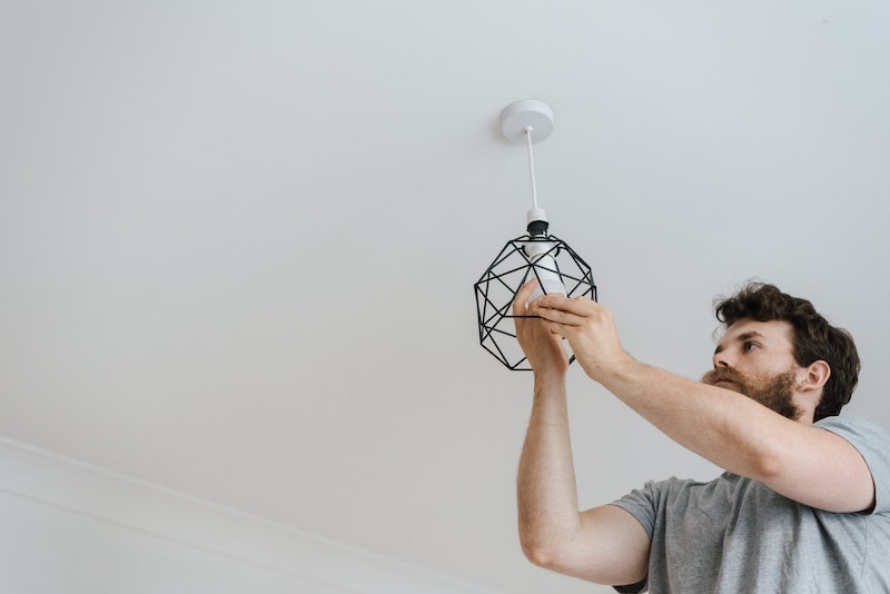 tenant changing the light bulb in Toowoomba property