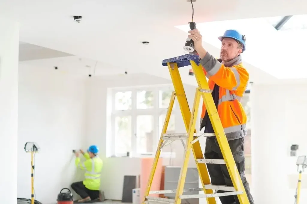 Electricians rewiring a house